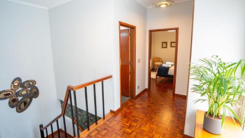 a hallway with a staircase and a living room at Starry View in Funchal