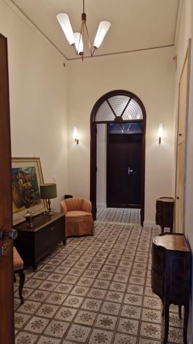 a living room with a black door and a couch at Casa Graziella in Capo dʼOrlando