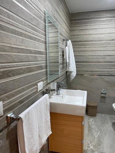a bathroom with a sink and a mirror at Dar Residence - Madinaty B12 - U1 - 3 BR - New Cairo in Madinaty