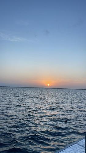 a sunset over a large body of water at Airport waterfront chalet in Katunayake
