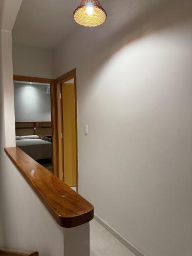 a hallway with a wooden stair case and a mirror at Paraíso dos Lençóis casa 08 Atins in Atins