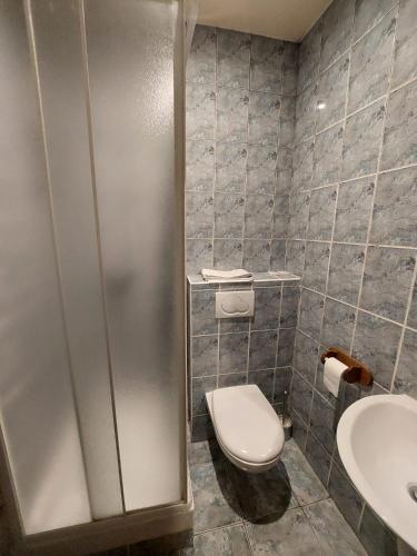 a bathroom with a toilet and a sink at Résidence Molière Hôtel Paris Montrouge in Montrouge