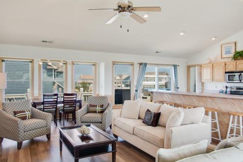 a living room with a couch and a table at Seaside 46 in Nags Head