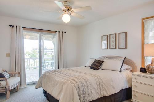 a bedroom with a bed and a ceiling fan at Seaside 46 in Nags Head