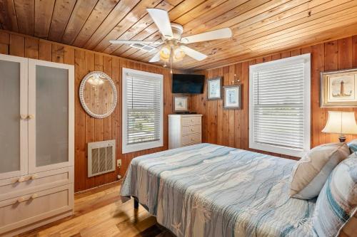 a bedroom with a bed and a ceiling fan at Seasons in the Sun in Nags Head