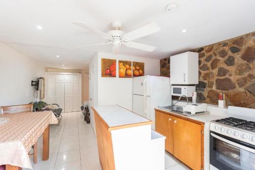 a kitchen with a white refrigerator and a table at Studio Bella in Philipsburg