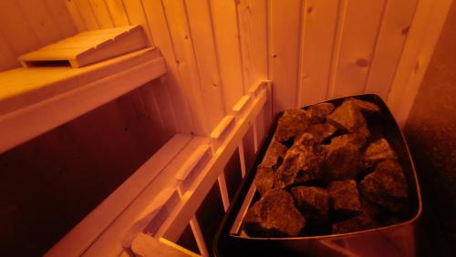 a tub full of rocks in a corner of a room at Casa rural Tío Quico in Granja de Moreruela
