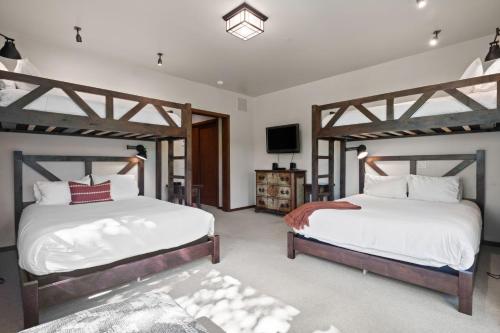 a bedroom with two twin beds and a tv at RMR: Timbers at Granite Ridge 3100 in Teton Village in Teton Village