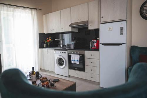a kitchen with a white refrigerator and a dishwasher at Elite luxury Suites in Omodos