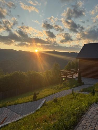 a view of the sunset from a cabin at Садиба Трембіта з сауною та чаном in Rakhiv