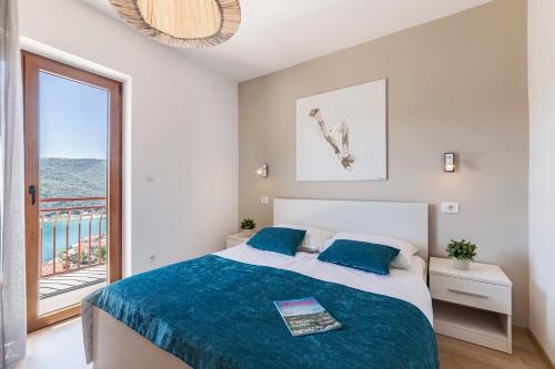a bedroom with a bed and a balcony at Three-Bedroom Apartment Rabac near Sea in Rabac