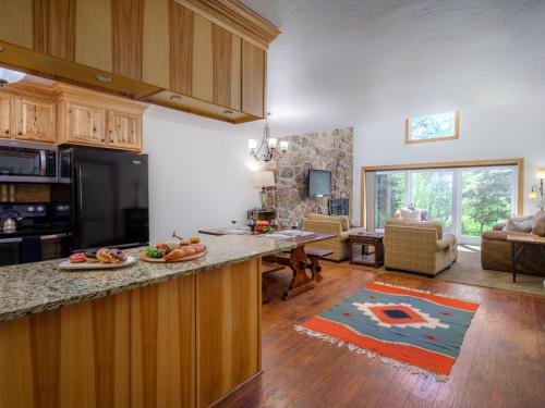 a kitchen with a counter and a living room at RMR: Four Seasons I 2 Condo in Teton Village in Teton Village