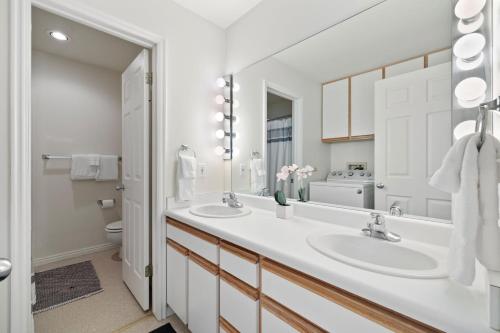 a bathroom with two sinks and a large mirror at RMR: Mountain Maple 4 Condo in The Aspens in Wilson