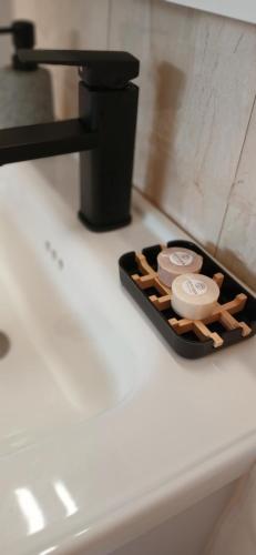 a tray with a watch sitting on a counter next to a sink at Traditional Grandma's house in Chios