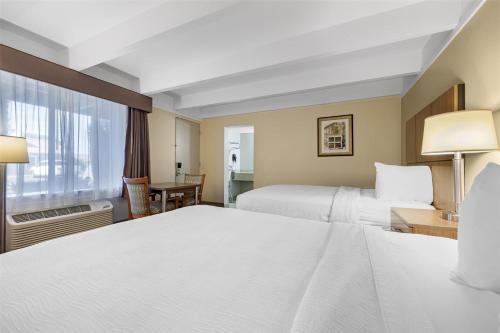 a hotel room with two beds and a window at Best Western El Rancho Palacio in Roswell
