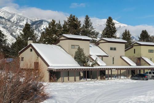 a row of houses with snow on the roofs at RMR: Hawthorne 222 Condo in The AspensWilsonWY in Wilson