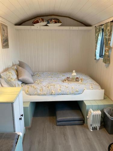 a bedroom with a bed in a small room at Crabmill glamping bewdley in Bewdley