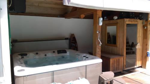 a jacuzzi tub in the middle of a room at Au Cœur De La Riviera Des Alpes T2 in Brison-Saint-Innocent