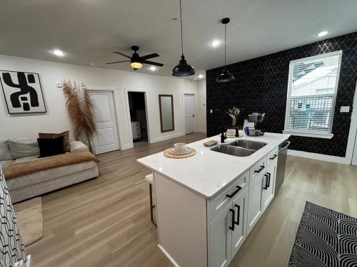 a kitchen with a sink and a living room at Houston Luxury 2bd Apartment in Houston