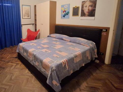 a bedroom with a bed and a red chair at Medusa Home & Relax in Porto SantʼElpidio