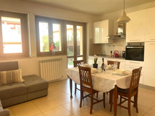 a kitchen and dining room with a table and chairs at Casa Junea in Maccarese