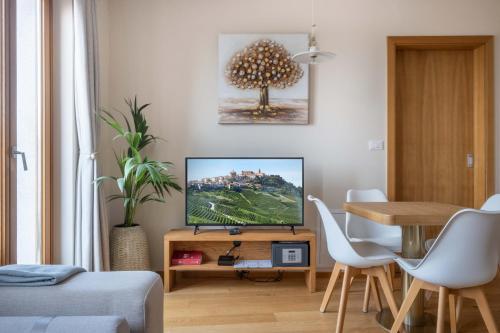 a living room with a tv and a table at Suites DANICA in Šmartno