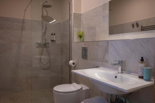 a bathroom with a toilet and a sink and a shower at Suites DANICA in Šmartno