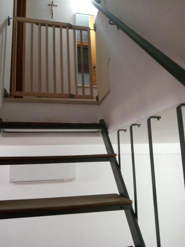a stair case in a church with a cross at Raggio Di Sole in Alberobello