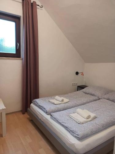 a bedroom with a bed with two towels on it at Barackvirág in Balatongyörök