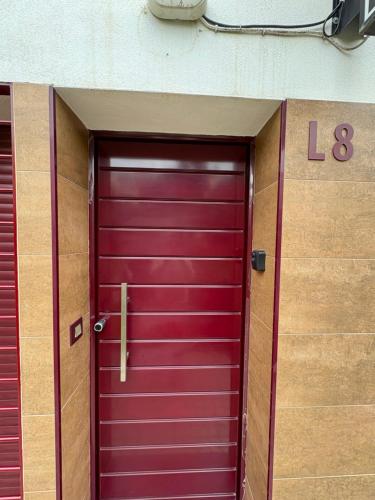 a purple door on the side of a building at Apartamentos Pintor Losada in Córdoba