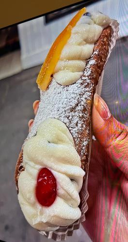 a persons hand holding a dessert with a fruit on it at Borbon Home luxury rooms & SPA in Palermo