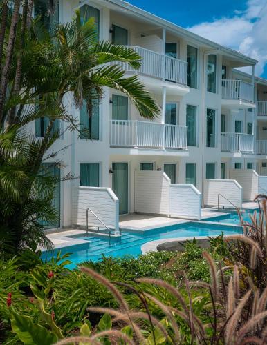 a hotel with a swimming pool in front of a building at Secrets Saint Lucia Resort & Spa - All Inclusive in Gros Islet