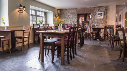 a dining room with wooden tables and chairs at Loch Ness Inn in Drumnadrochit