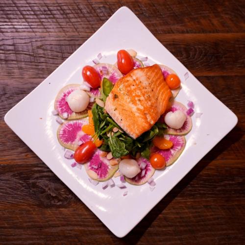 a plate of food with fish and vegetables on it at Flying Saddle Resort and Steak House in Alpine