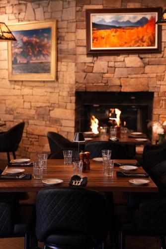 a table in a restaurant with a fireplace at Flying Saddle Resort and Steak House in Alpine