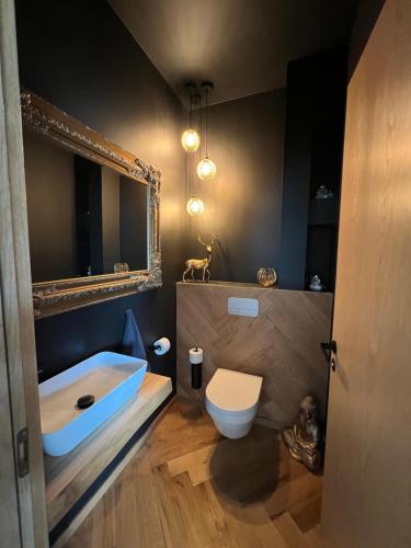 a bathroom with a tub and a toilet and a sink at Männi Villa in Haaslava
