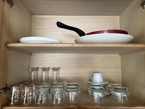 a wooden shelf with glass jars and a utensil at Nouveau Studio avec la climatisation M2 in Tangier