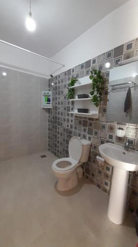 a bathroom with a toilet and a sink at Rouge Azur Saidia in Saïdia