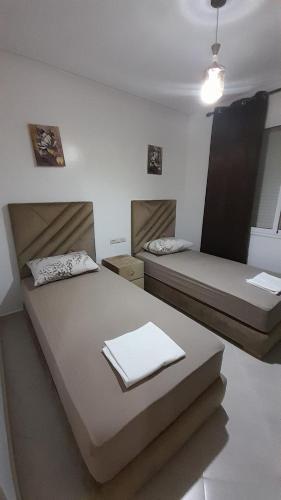a room with two beds in a room at Rouge Azur Saidia in Saïdia