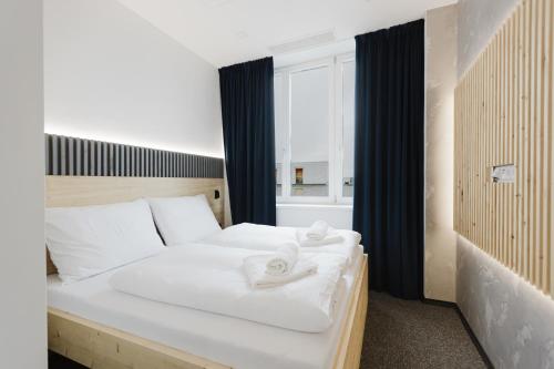 a bedroom with a bed with white towels on it at Apartmány Prusinovského in Kroměříž