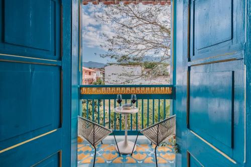 an open door with a table on a balcony at Hotel Fundadores en Cauca Viejo Fundadores in Jericó