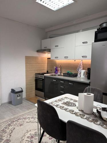 a kitchen with a table with chairs and a refrigerator at Apartment Alisa in Vlasic