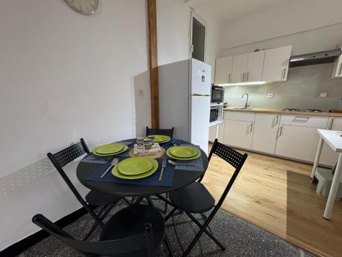 a dining room table with four chairs in a kitchen at Appartement moderne et cosy in Rabat