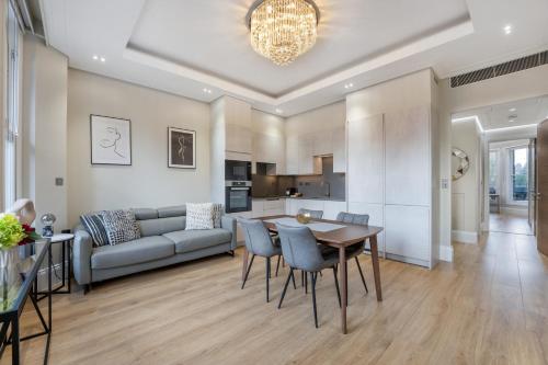 a living room with a couch and a table and chairs at LuxLet Apartments - Heart of Hampstead, London in London