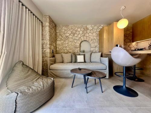 a living room with a couch and a table at Linen by Goutos Luxury Living in Kranidi