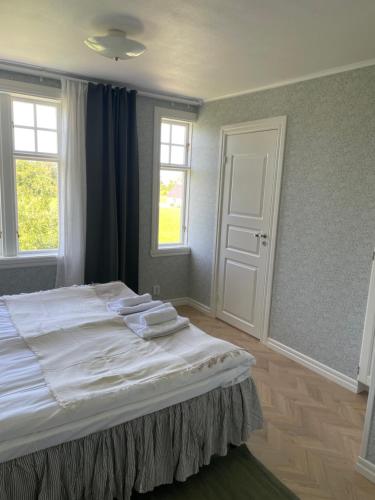 a bedroom with a large bed with towels on it at Pensionat Haga Öland in Löttorp