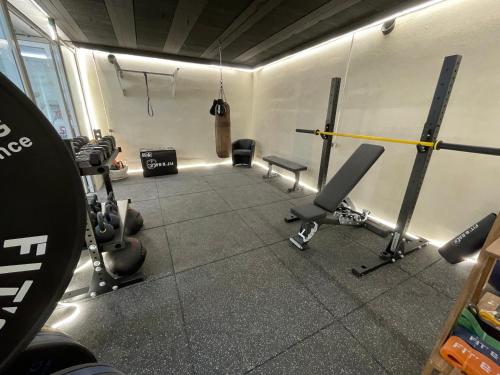 a gym with several treadmills and weights at Villa provençale Golfe St Tropez climatisée piscine chauffée, Spa, billard, Wifi haut débit pro in Gassin