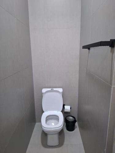 a bathroom with a white toilet in a stall at WeStay Nova Cidade in São Paulo