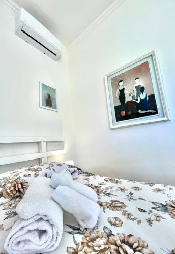 a bedroom with a bed with a picture on the wall at Alloggio Primavera Matilde in Terni