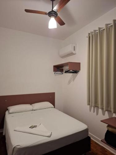 a bedroom with a bed with a ceiling fan at WeStay Nova Cidade in São Paulo
